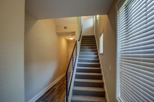 stairs with hardwood / wood-style flooring