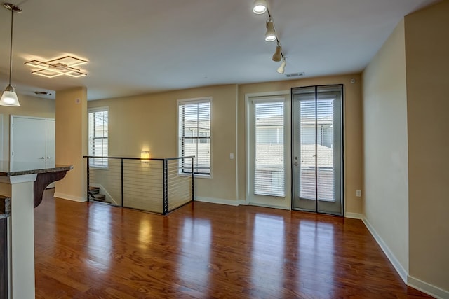 unfurnished living room featuring dark hardwood / wood-style flooring