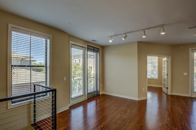 entryway featuring rail lighting and dark hardwood / wood-style flooring