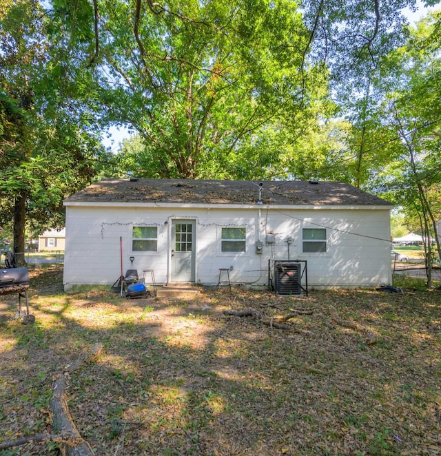 rear view of property with central AC