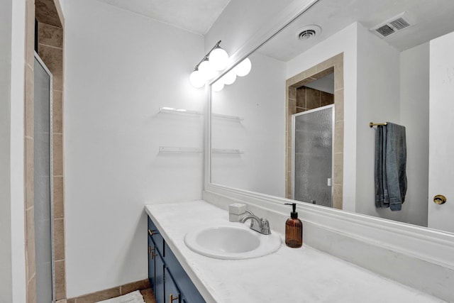 bathroom featuring vanity and a shower with shower door