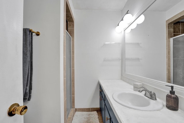 bathroom featuring walk in shower and vanity