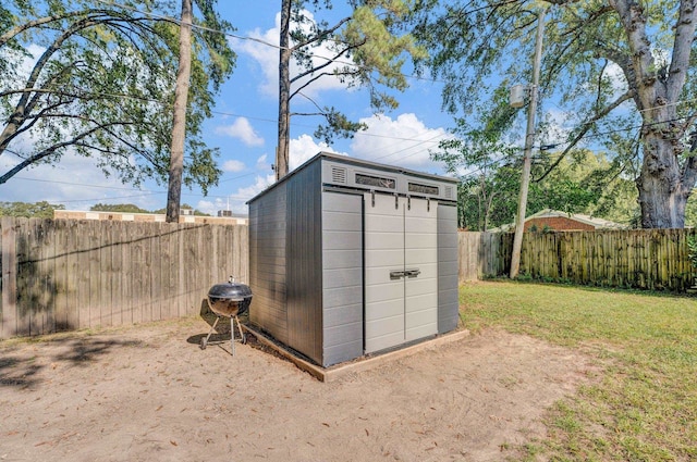 view of outbuilding with a yard