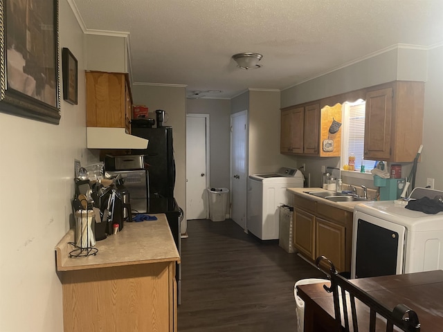 kitchen with washer and dryer, crown molding, and dark wood-type flooring