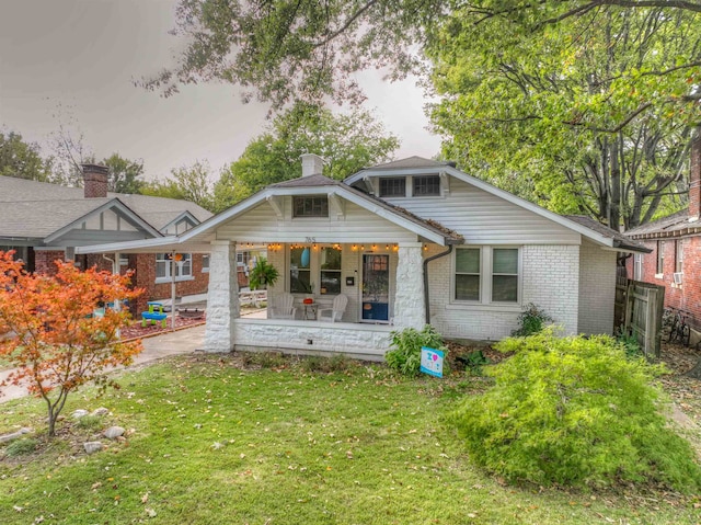 rear view of house featuring a yard