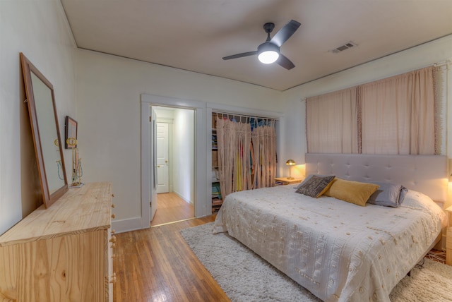 bedroom with ceiling fan, light wood-type flooring, and a closet