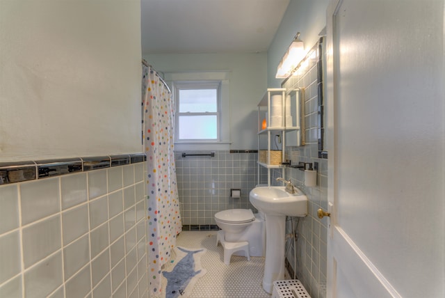 bathroom featuring walk in shower, tile walls, toilet, and tile patterned floors