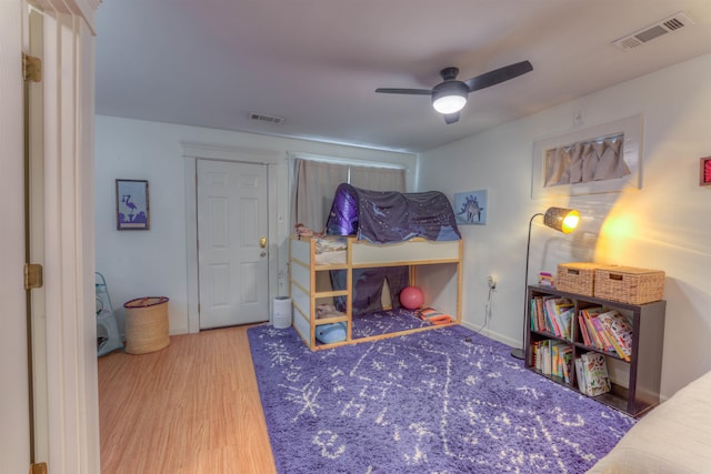 bedroom with ceiling fan and hardwood / wood-style floors