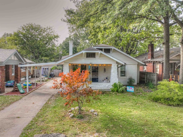 view of front of property with a lawn and covered porch