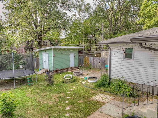 view of yard with a shed and a trampoline