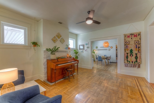 interior space with parquet flooring and ceiling fan