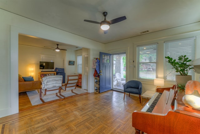 living room featuring parquet flooring and ceiling fan