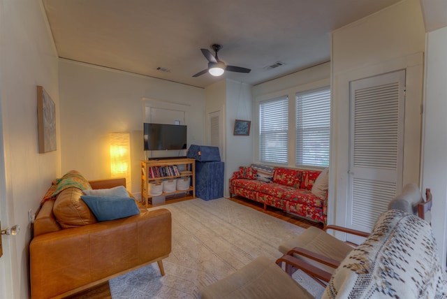 living room featuring hardwood / wood-style floors and ceiling fan