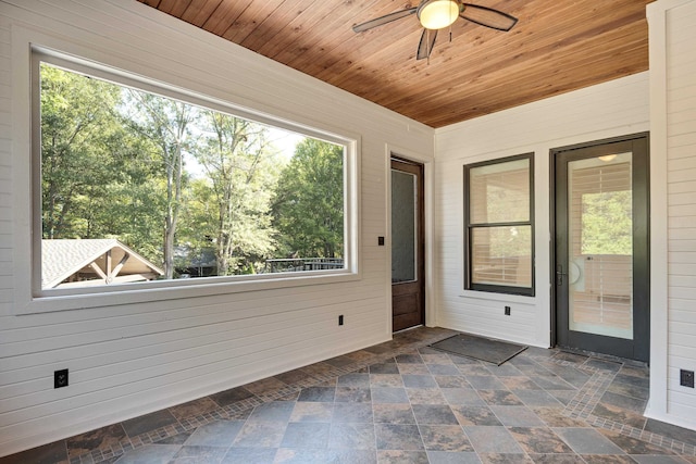 unfurnished sunroom with ceiling fan and wooden ceiling