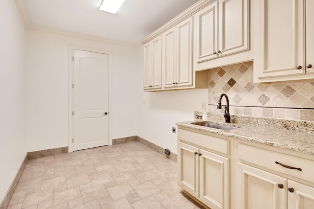 clothes washing area with washer hookup, ornamental molding, sink, hookup for an electric dryer, and cabinets