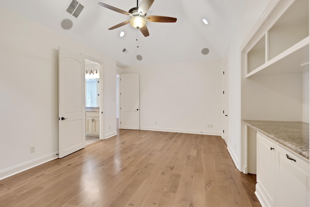 interior space featuring ceiling fan, lofted ceiling, and light hardwood / wood-style floors