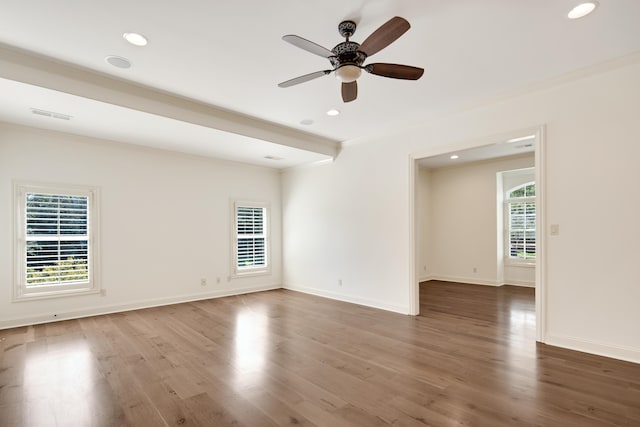 empty room featuring ornamental molding, ceiling fan, and wood-type flooring