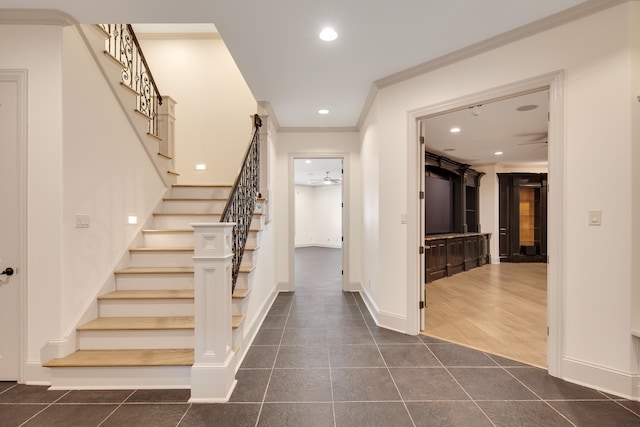 interior space featuring ornamental molding, ceiling fan, and dark hardwood / wood-style flooring