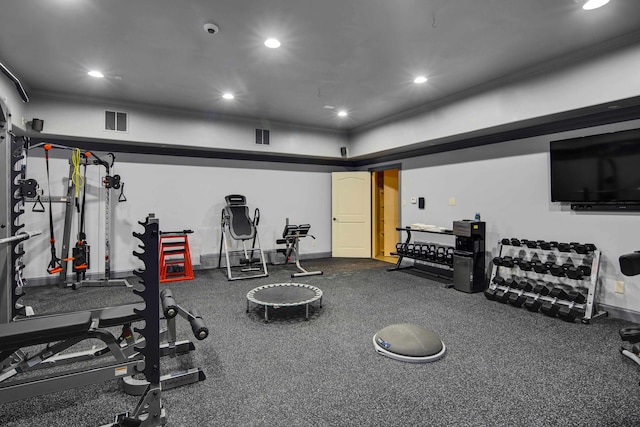 workout area featuring crown molding