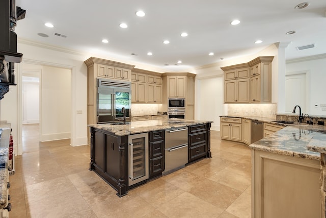 kitchen with beverage cooler, crown molding, light stone counters, backsplash, and built in appliances