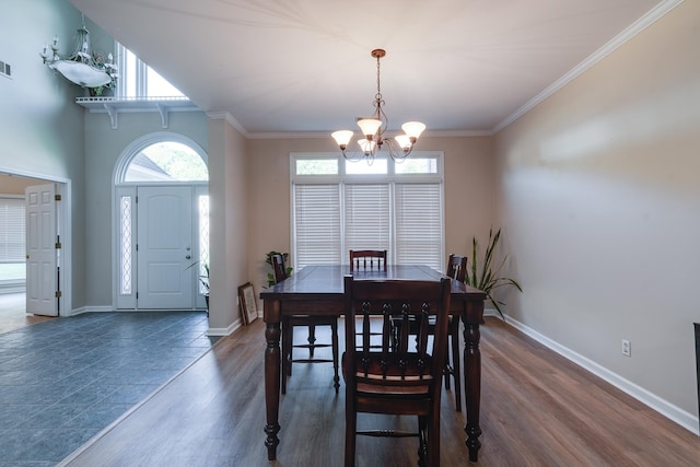 dining room with an inviting chandelier, dark hardwood / wood-style floors, and ornamental molding