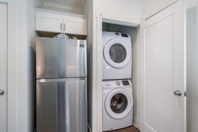 washroom featuring stacked washer and clothes dryer and crown molding