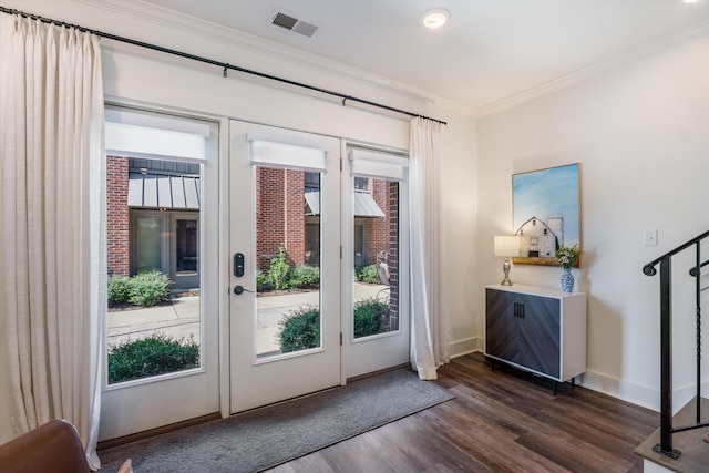 doorway featuring french doors, ornamental molding, and dark wood-type flooring