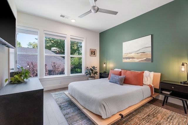 bedroom with ceiling fan and wood-type flooring