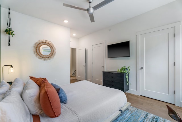 bedroom with light wood-type flooring and ceiling fan