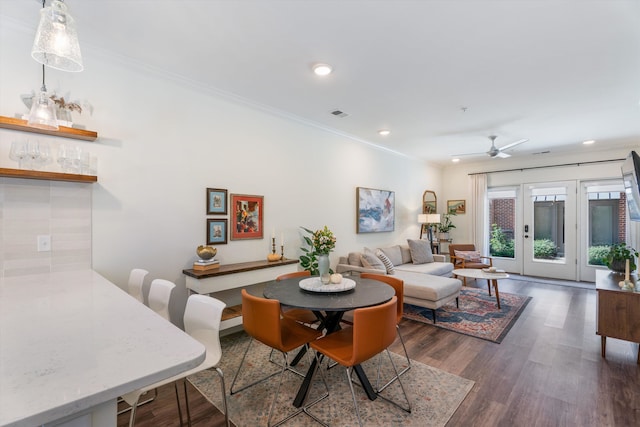 dining room with ornamental molding, ceiling fan, french doors, and dark hardwood / wood-style flooring