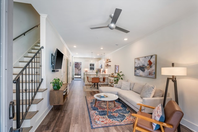 living room featuring crown molding, dark hardwood / wood-style flooring, and ceiling fan