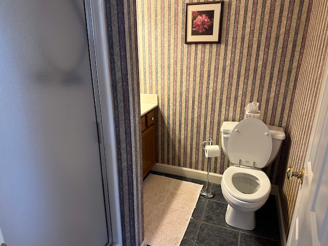 bathroom featuring vanity, an enclosed shower, tile patterned floors, and toilet