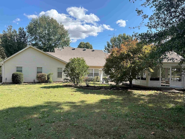 rear view of property with a yard