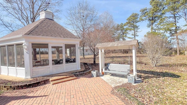 view of patio featuring a sunroom