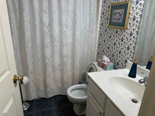 bathroom with vanity, tile patterned floors, and toilet