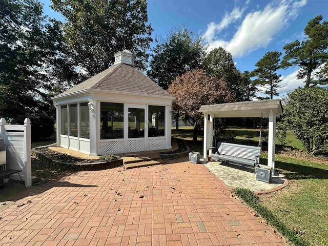 view of patio with a sunroom