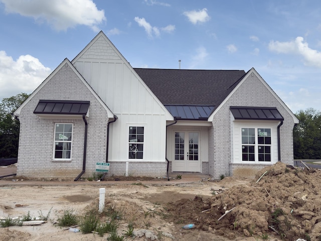 6284 Bevan Lake Dr, Arlington, TN 38002 - modern farmhouse style home featuring french doors, a standing seam roof, brick siding, and board and batten siding