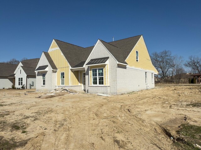 6284 Bevan Lake Dr, Arlington, TN 38002 - view of front facade featuring board and batten siding, brick siding, and roof with shingles