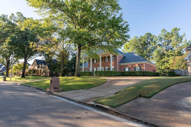 greek revival house with a front yard