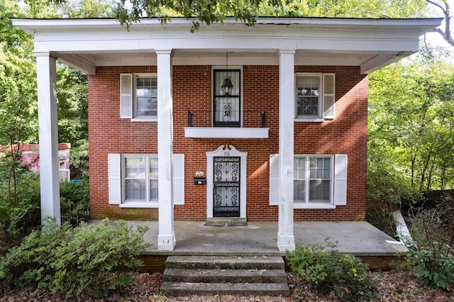 greek revival inspired property featuring covered porch