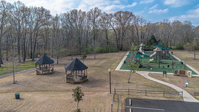 surrounding community with a lawn, a gazebo, and a playground