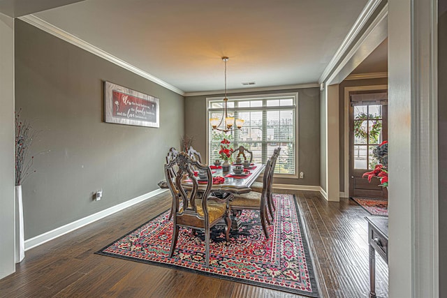 dining space featuring ornamental molding, dark hardwood / wood-style floors, and a chandelier