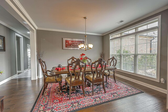 dining room with a notable chandelier, crown molding, and dark hardwood / wood-style flooring