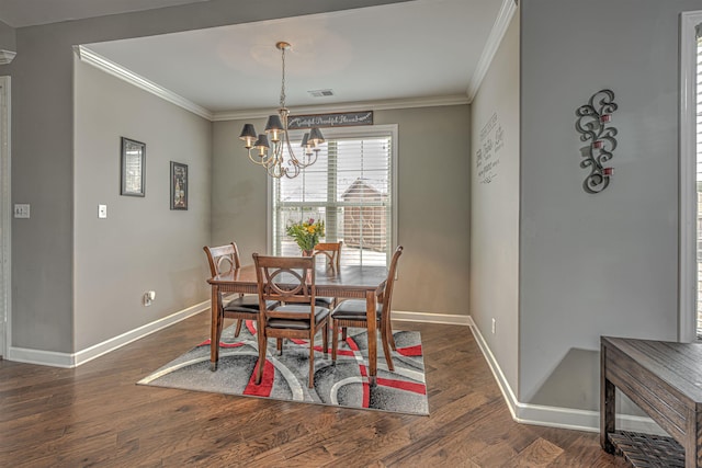 dining area featuring ornamental molding, dark hardwood / wood-style floors, and a chandelier