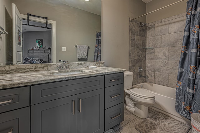 full bathroom featuring tile patterned floors, shower / bath combo with shower curtain, vanity, and toilet