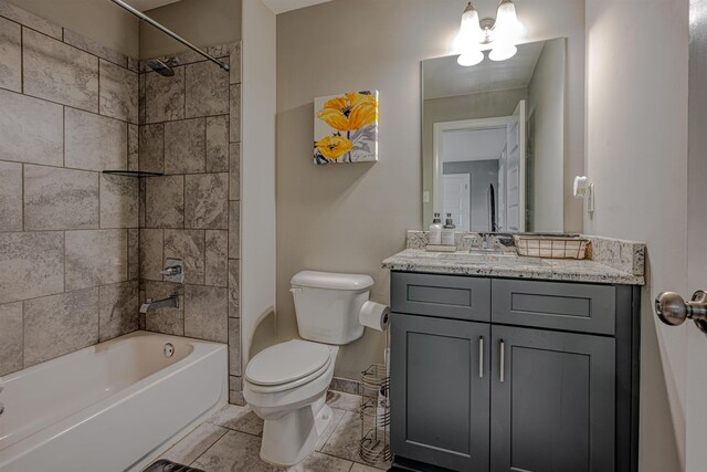 full bathroom with toilet, vanity, tile patterned flooring, and tiled shower / bath combo