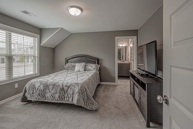 carpeted bedroom featuring connected bathroom