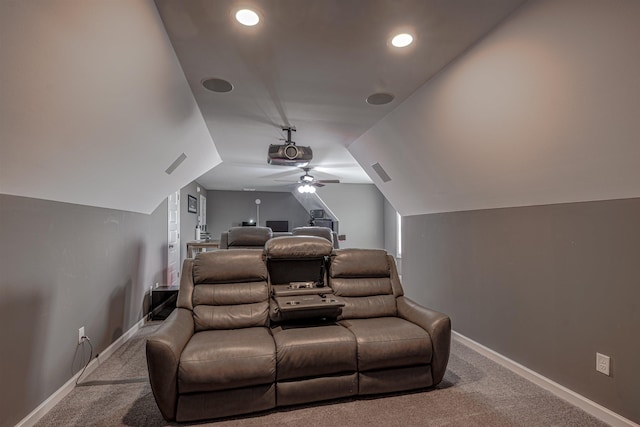 home theater with ceiling fan, light colored carpet, and lofted ceiling