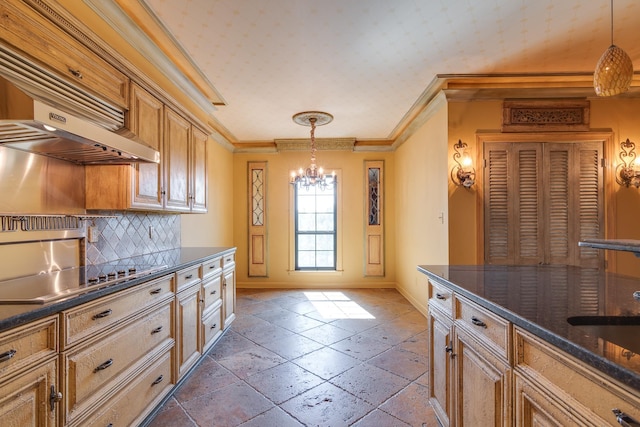 kitchen featuring a chandelier, stone tile flooring, black electric cooktop, dark countertops, and baseboards