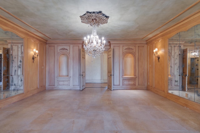 unfurnished dining area with a chandelier and ornamental molding